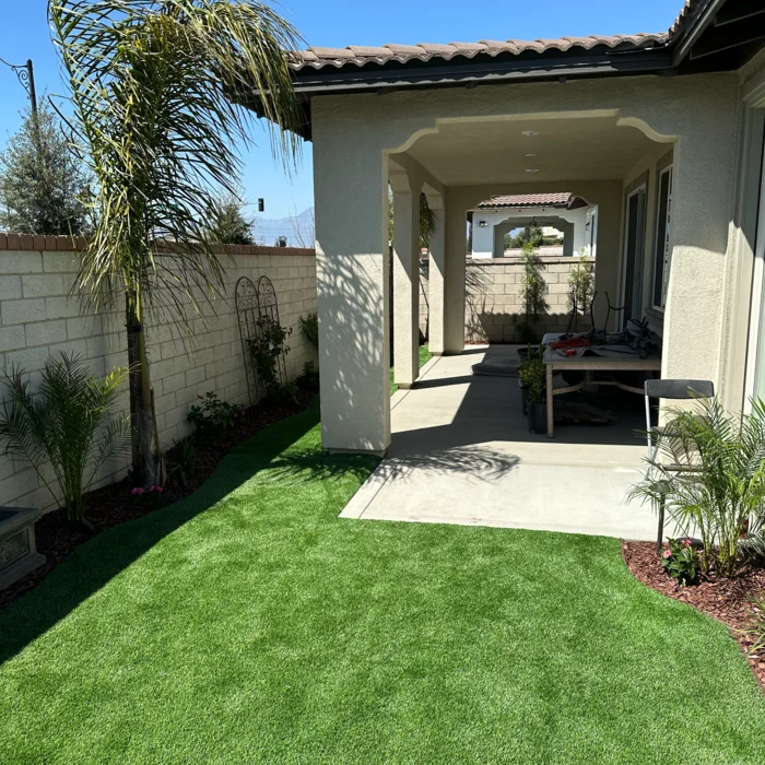 Artificial turf backyard with covered patio