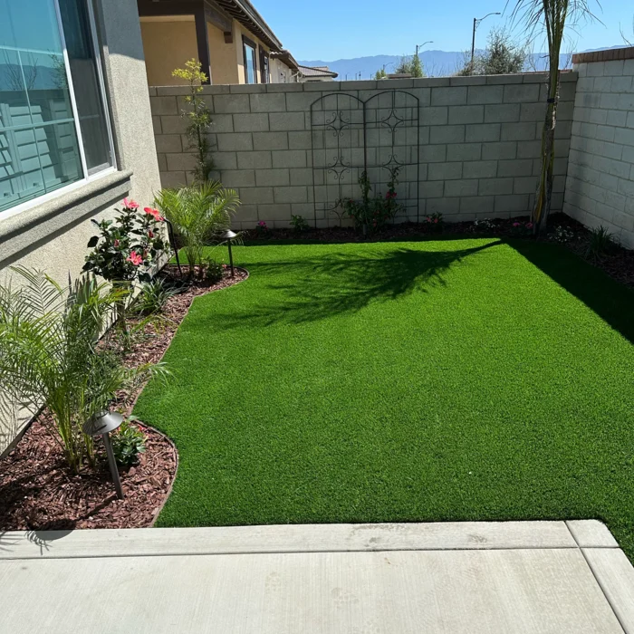 Artificial turf lawn installation with fresh planting beds