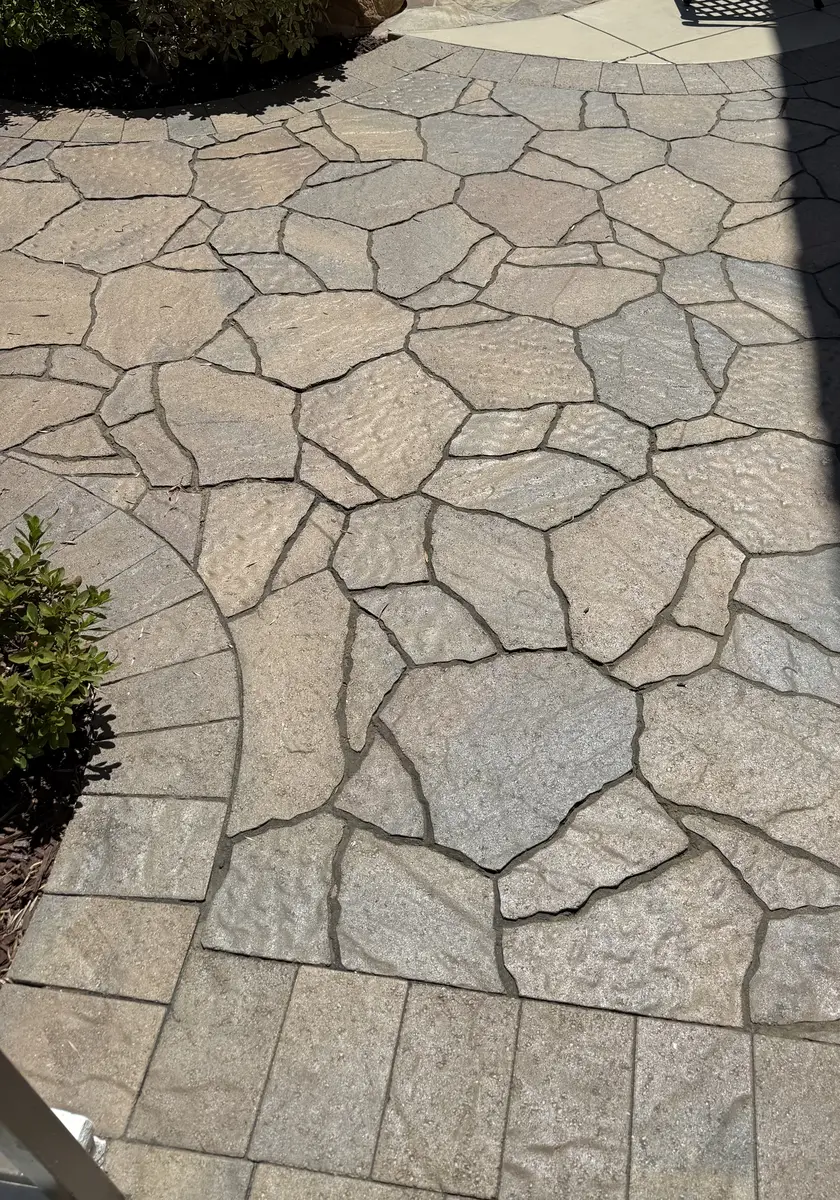 Flagstone-pattern paver walkway installation