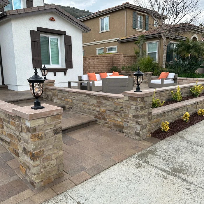 Front courtyard with stone seating walls, pavers and lighting