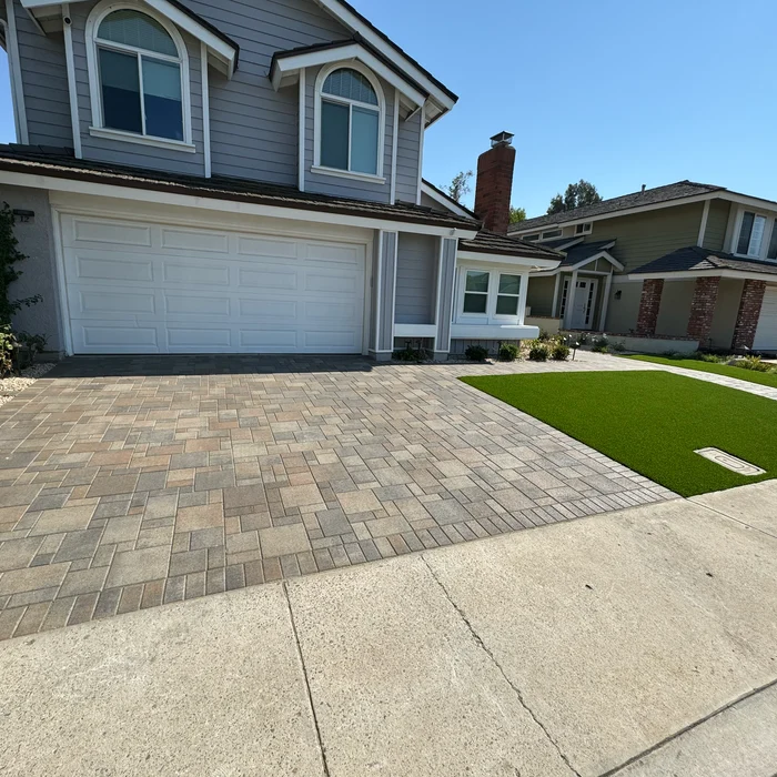Paver driveway with artificial turf front lawn