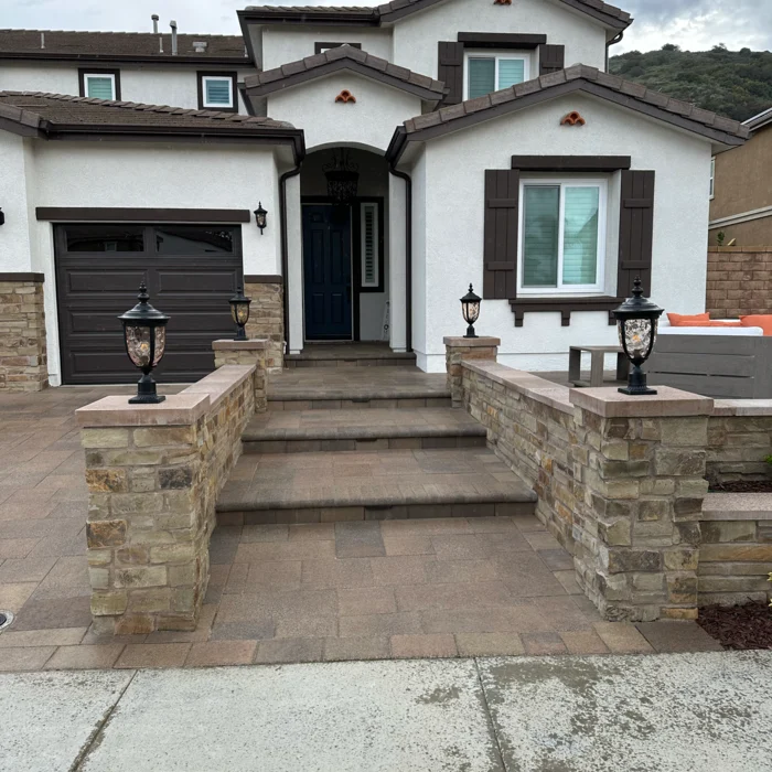 Paver entry steps with stone pillars and lantern lighting