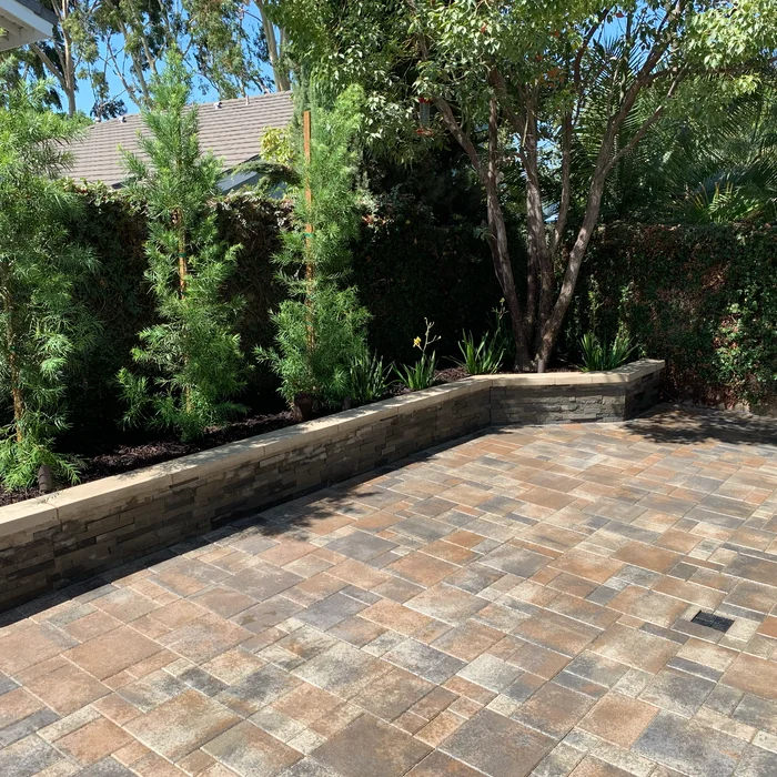 Paver patio with stone planter retaining wall