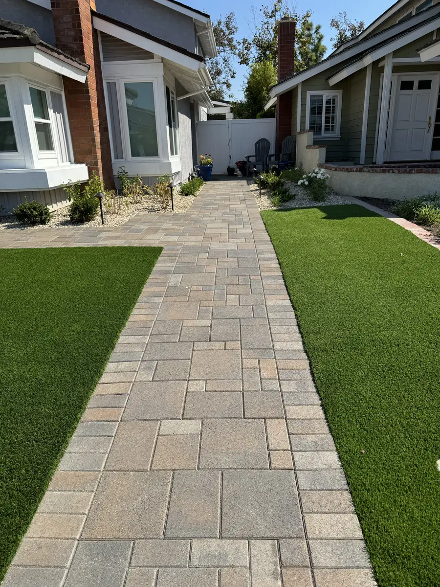 Side-yard paver walkway with artificial turf border