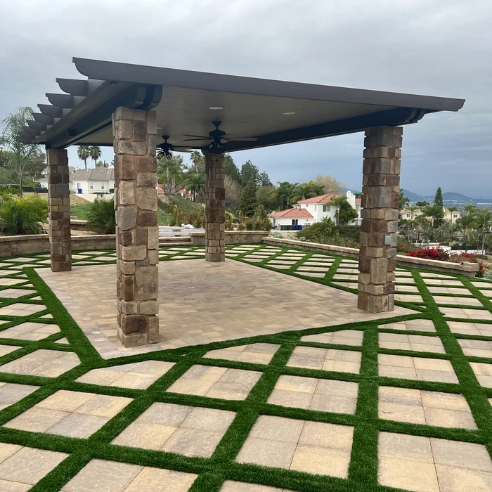 Pergola with stone columns over paver and turf grid patio