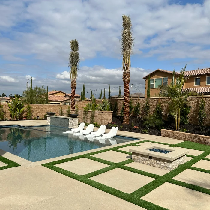 Pool area with fire pit, loungers and desert landscaping