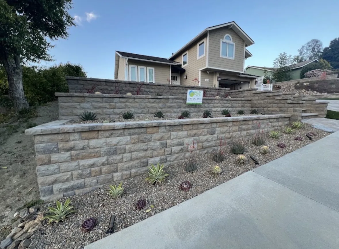 Tiered block retaining walls with drought-tolerant slope planting