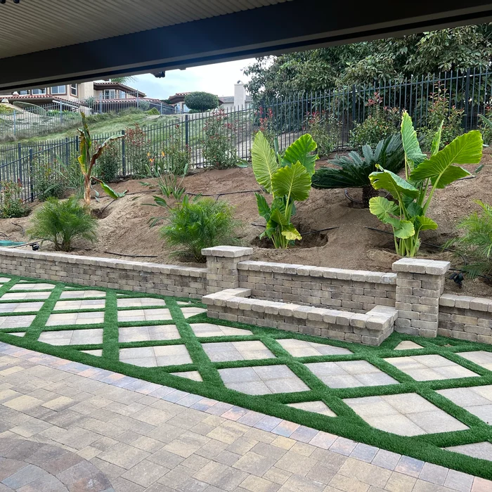 Tropical landscaping with paver and turf grid patio